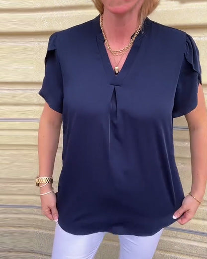 Blusa coordinata a pieghe con scollo a V in tinta unita