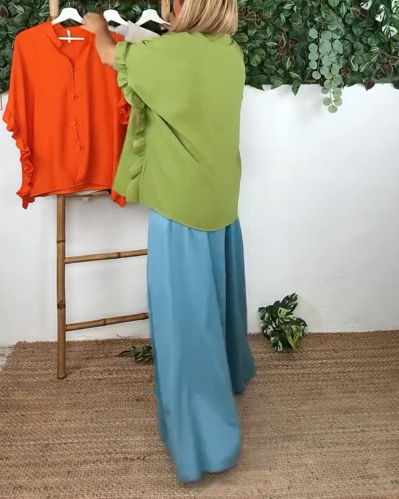 Camicia con maniche a pipistrello e bottoni sul risvolto