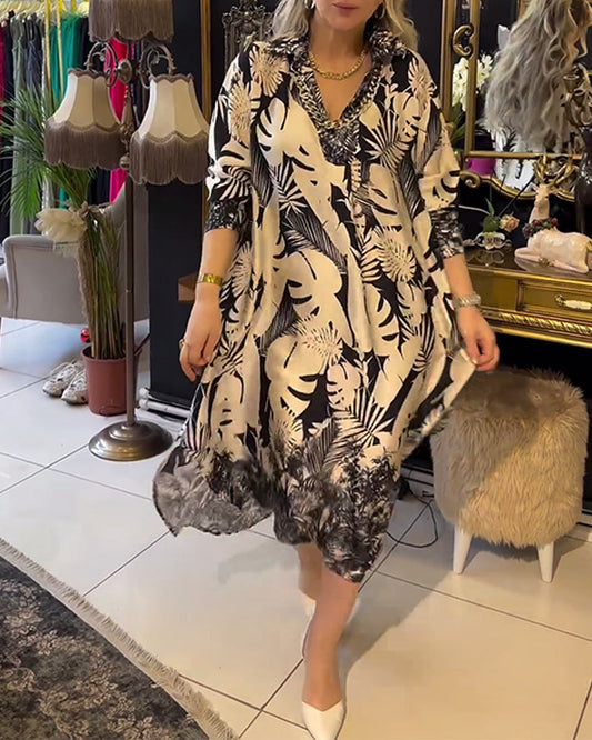 Elegant midi dress with leaf pattern and lapel cut