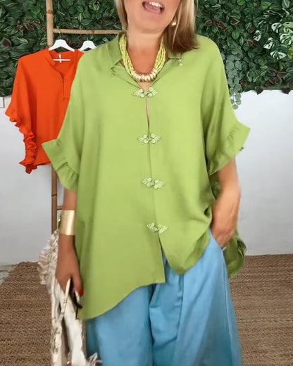 Camicia con maniche a pipistrello e bottoni sul risvolto